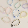 Cross-border Daisy flower keychain mobile phone chain, candy-colored cute water bottle, coffee cup with pendant chain, mobile phone lanyard for women details Picture